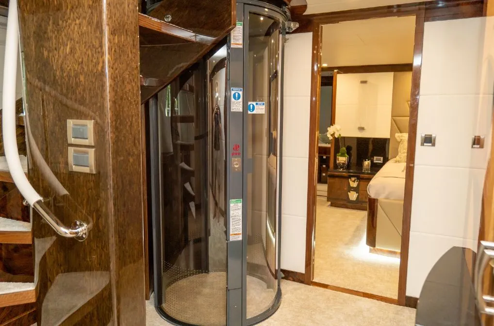 PVE pneumatic vacuum elevator installed between a wood staircase and staterooms aboard a yacht