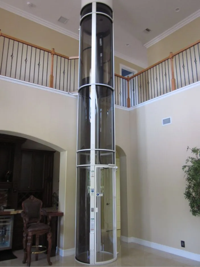 PVE37 pneumatic vacuum elevator with 360 degree panoramic view installed in a two story foyer