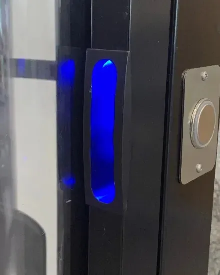 Illuminated blue LED handle on a PVE home elevator aluminum door frame