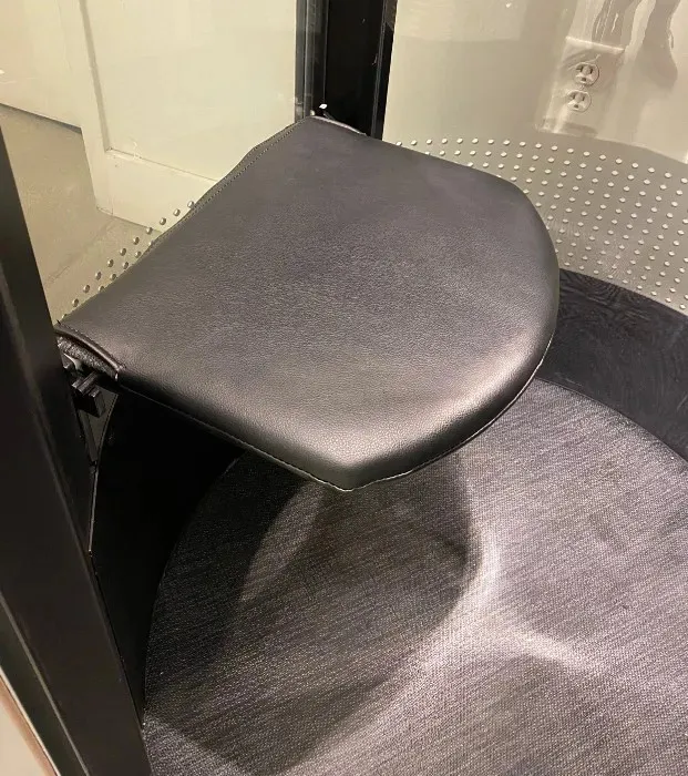 Fold down leather seat with handle inside a PVE home elevator cabin