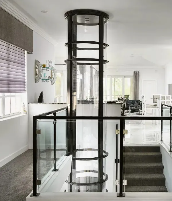 PVE home elevator with clear polycarbonate panels installed in a modern two story living room