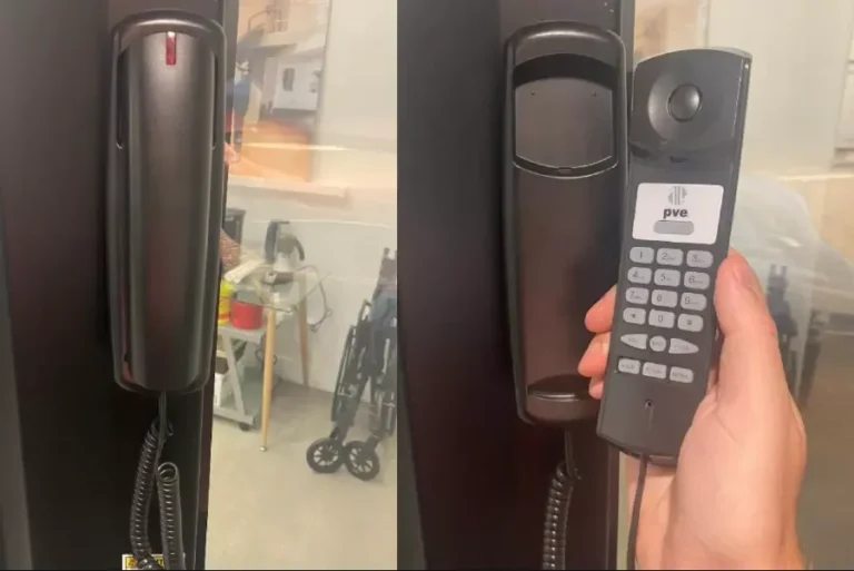 PVE elevator cabin telephone mounted on wall and held in hand for two way emergency communication