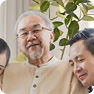 Smiling customer Stan Barth with family sharing his review of a PVE home elevator