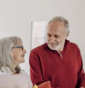 Smiling senior couple sharing a happy moment, featured in a PVE home elevator customer testimonial